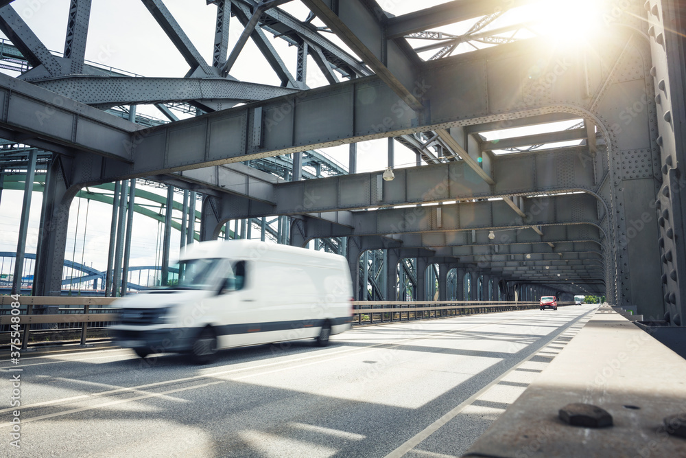 Van driving over an industrial style bridge Van driving over an industrial style bridge