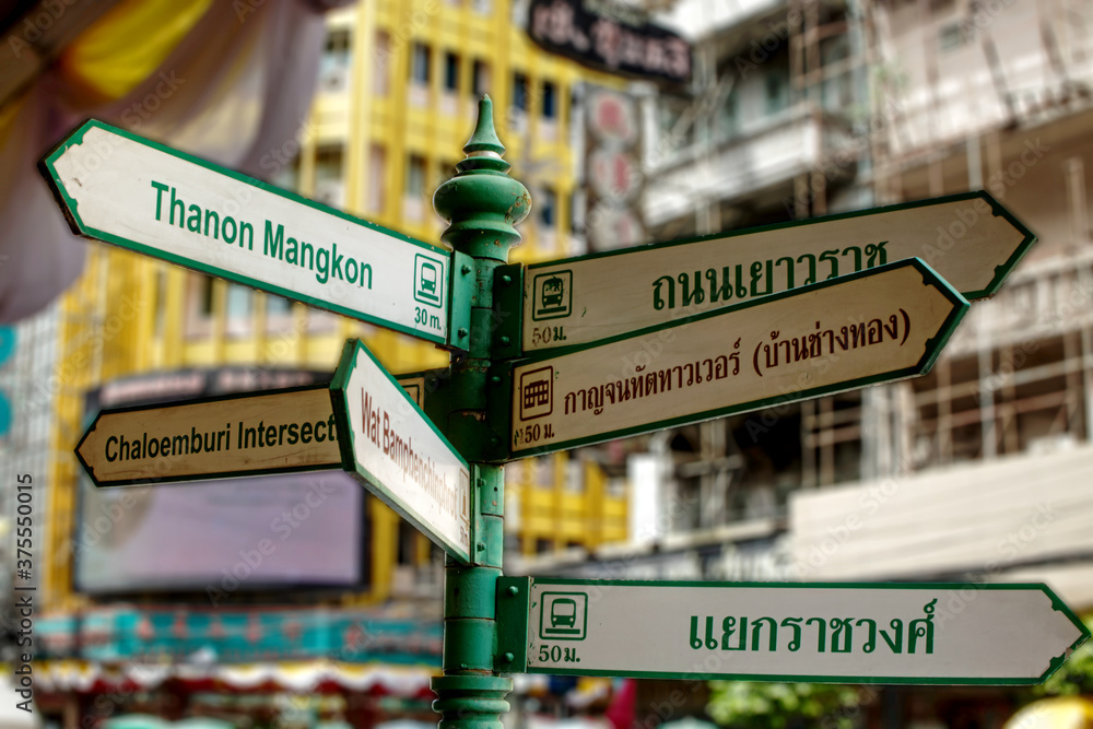 China Town, Bangkok, Thailand - 16 April 2018 : A pole with six way findings or signage on it, locates along the street. Vintage style and Classic design.