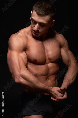 Portrait of muscular bodybuilder on black background.Studio shot