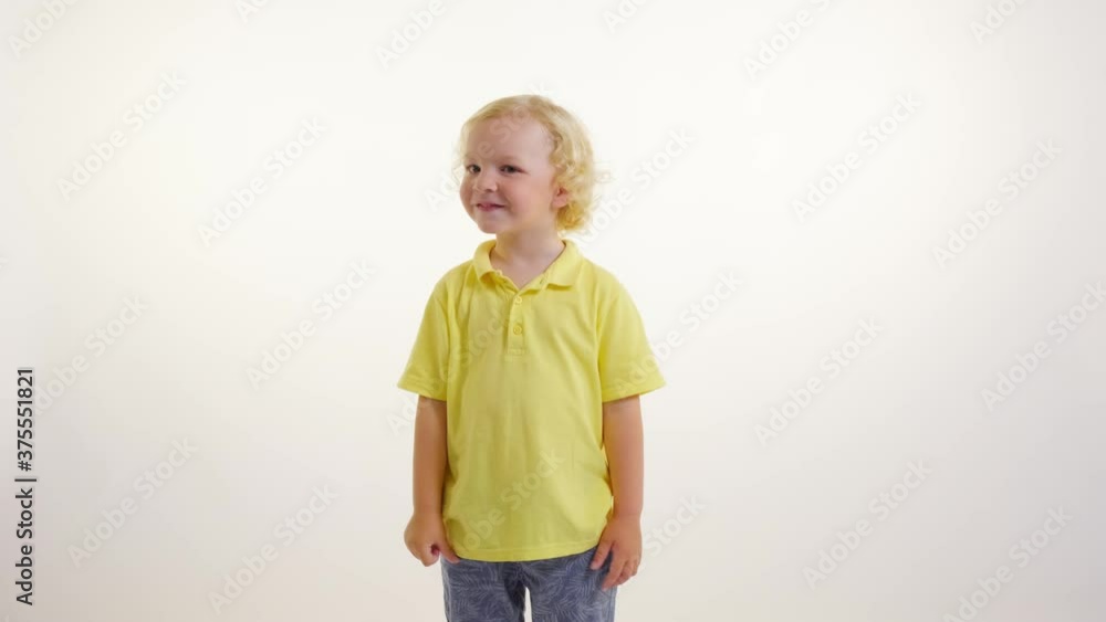 Blond curly boy showing thumbs up gesture, super approval. White isolated background. Blond curly boy showing thumbs up gesture, super approval. White isolated background.