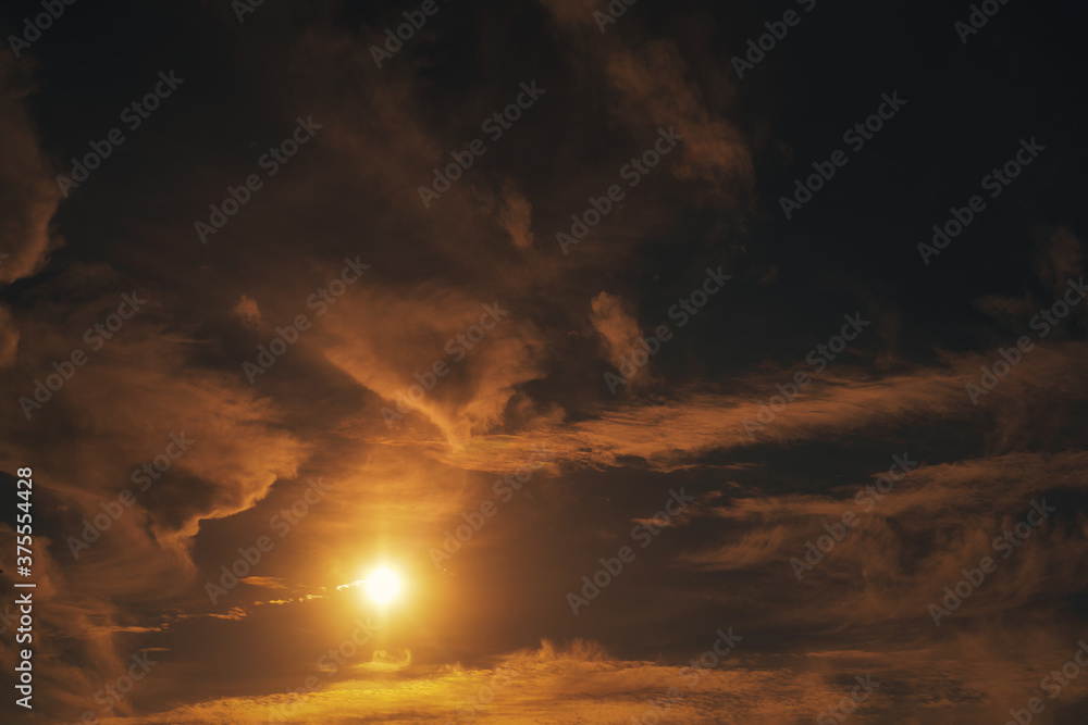 Sunset sky with clouds and sun. Abstract Natural background and texture. Retro image tone