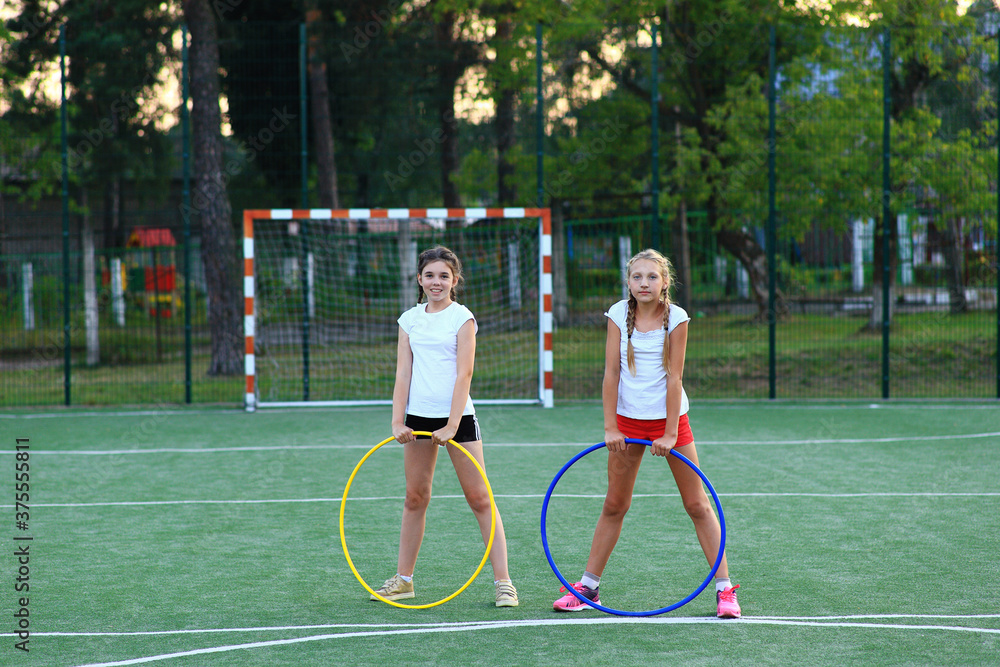 two girls go in for sports on the playground