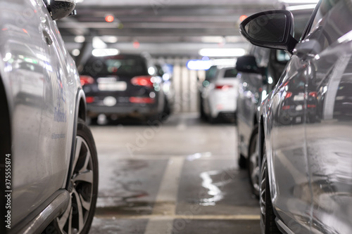 Underground garage or modern car parking with lots of vehicles, perspective © lightpoet