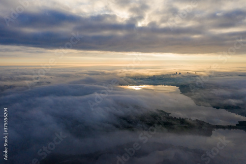 Photo of the city lake in Minsk through the fog! Sunrise! Fog and building through the fog! Minsk! Belarus.