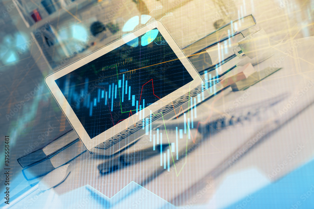 Stock market chart hologram drawn on personal computer background. Double exposure. Concept of investment. Stock market chart hologram drawn on personal computer background. Double exposure. Concept of investment.