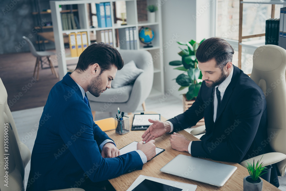Portrait of two nice attractive handsome classy elegant trendy men economist signing employment contract offer recruiting in light white interior work place station indoors Portrait of two nice attractive handsome classy elegant trendy men economist signing employment contract offer recruiting in light white interior work place station indoors