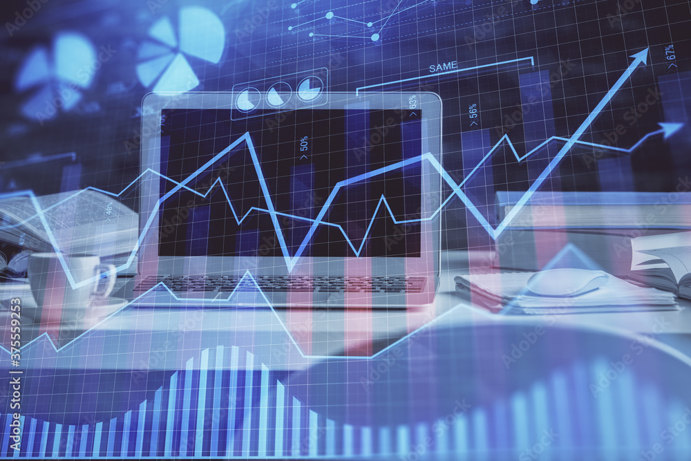 Financial graph colorful drawing and table with computer on background. Double exposure. Concept of international markets. Financial graph colorful drawing and table with computer on background. Double exposure. Concept of international markets.