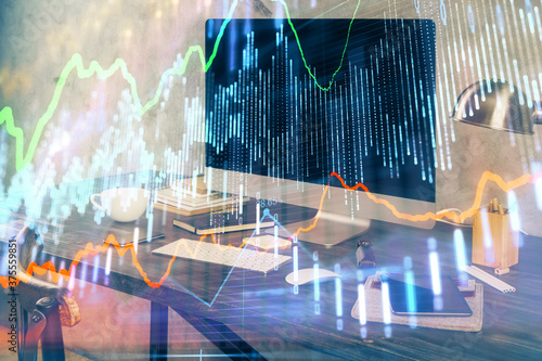 Financial graph colorful drawing and table with computer on background. Double exposure. Concept of international markets. © peshkova