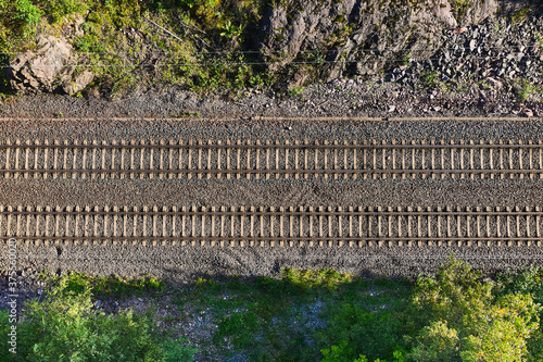 Obraz na płótnie Aerial view of the railway track. The railroad between the hills. w salonie