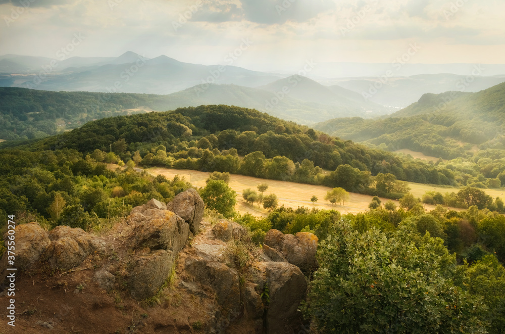 Aerial view on hills of Czech central mountains (ceske stredohori) from Lysa hora hill, Czechia
