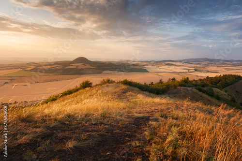 Obraz na płótnie Sunset light over Rana hill and Czech Central mountains (Ceske stredohori), Czechia w salonie