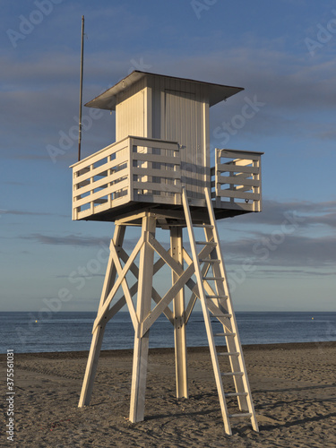 Lifeguard tower beach at sunrise with nobody