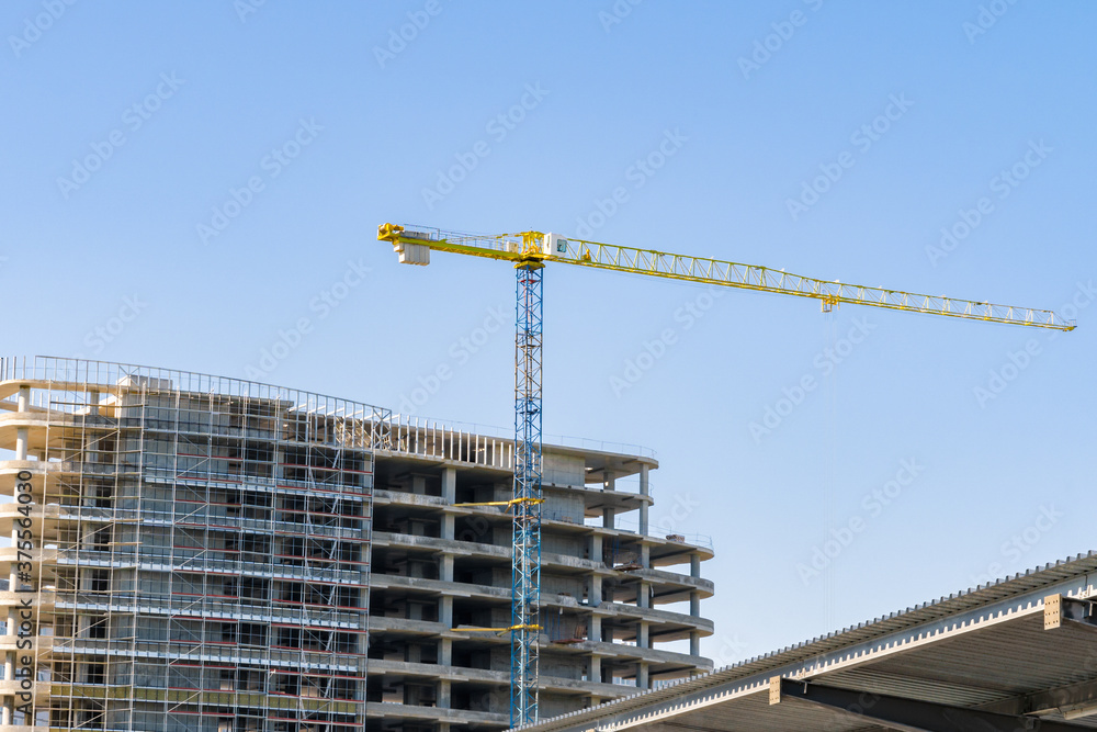 Fototapeta premium construction crane at the construction site of a high-rise building