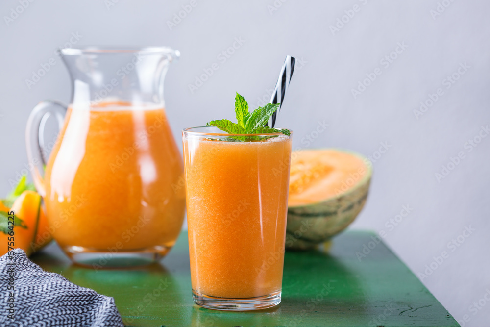 Fototapeta premium Fresh organic melon cantaloupe smoothie on a kitchen table