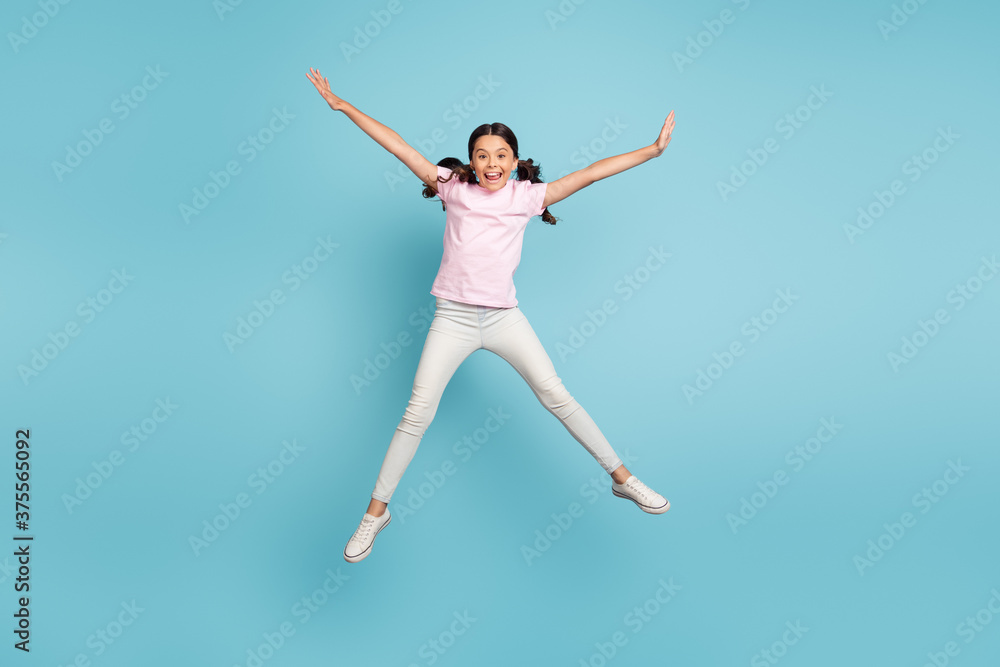 Full length body size view of her she nice attractive pretty carefree foolish cheerful cheery pre-teen girl jumping having fun fooling isolated over blue pastel color background
