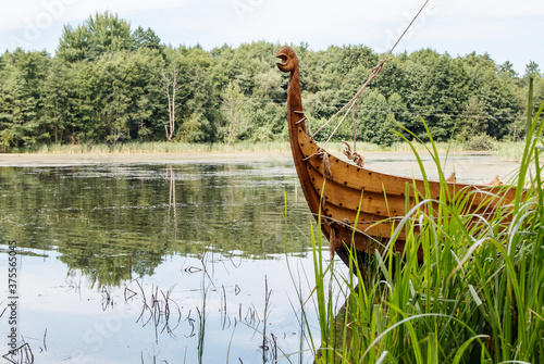 Fotografía old wooden viking boat by the lake