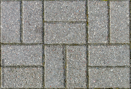 road paved with rhombus sidewalk tiles. texture of light gray bricks.