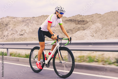 Young Woman Cyclist Riding Bike on the Mountain Road. Adventure, Healthy Lifestyle, Sport