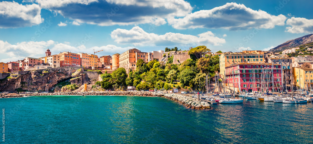 Panoramic spring cityscape of Bastia port. Exciting morning view of Corsica island, France, Europe. Bright  Mediterranean seascape with yacht and lighthouse. Traveling concept background.