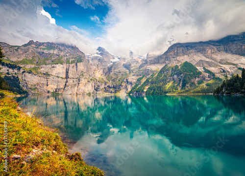 Attractive summer view of unique lake - Oeschinen (Oeschinensee), UNESCO World Heritage Site. Fantastic morning scene of Bernese Oberland Alps, Switzerland, Europe.