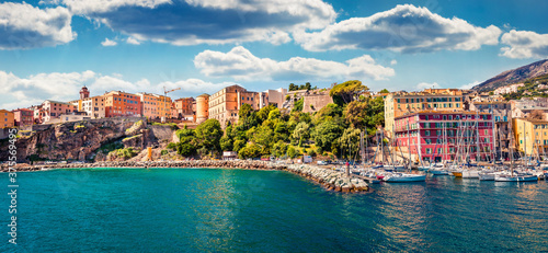 Panoramic spring cityscape of Bastia port. Exciting morning view of Corsica island, France, Europe. Bright Mediterranean seascape with yacht and lighthouse. Traveling concept background.