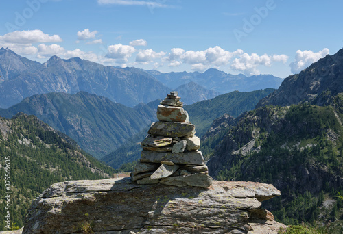 Stone pyramid along the mountain path - hope concept. © Alessandro