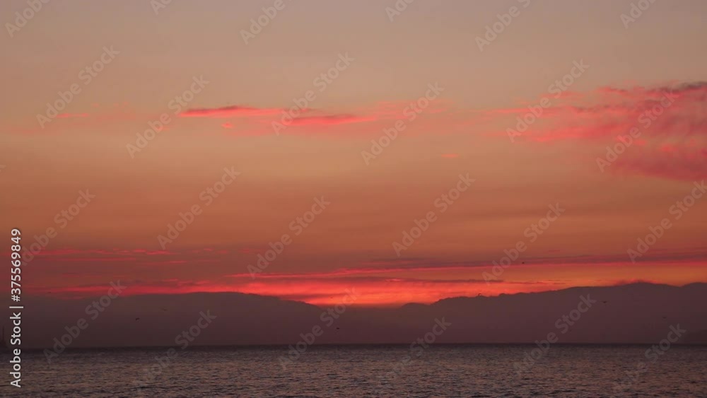 Stunning Red Sunset at Dusk on a Beautiful Summer Night in the San Francisco Bay with Alcatraz and the Golden Gate Bridge in the Distance Stunning Red Sunset at Dusk on a Beautiful Summer Night in the San Francisco Bay with Alcatraz and the Golden Gate Bridge in the Distance