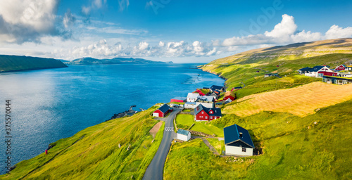 Green summer view from flying droneof Kirkjubour village with Hestur Island on background. Attractive morning scene of Faroe Islands, Denmark, Europe. Beauty of nature concept background. photo
