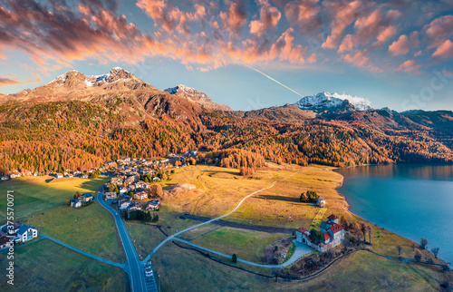 Magnificent evening view from flying drone of Silvaplana village, Maloja Region. Fantastic outdoor scene of Swiss Alps. Aerial autumn view of Silvaplanersee lake. Traveling concept background. photo