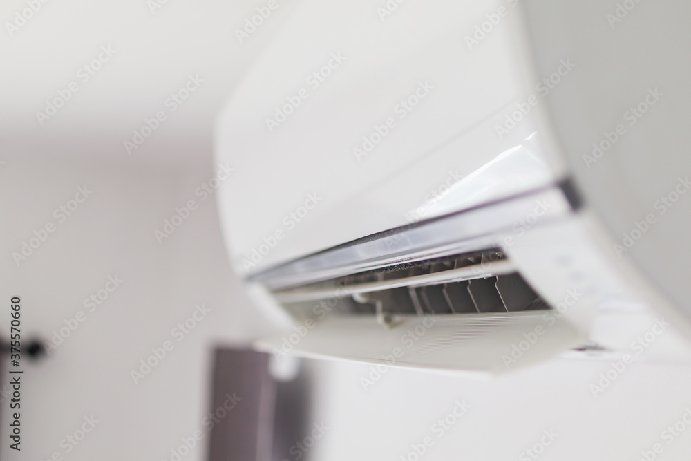 Air conditioner on white wall room interior background Air conditioner on white wall room interior background