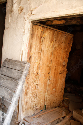 Abandoned Adobe House. Old ruined wooden door.