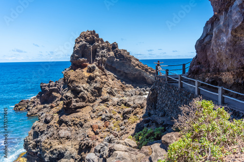 A young brunette looking from the viewpoint at Nogales beach in the east of La Plama Island, Canary Islands. Spain photo