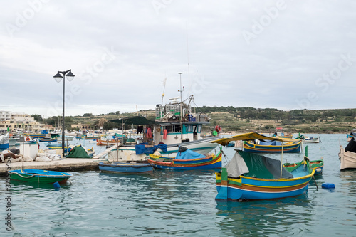The traditional maltese luzzu boats in the harbor of fishing village Marsaxlokk in Malta 