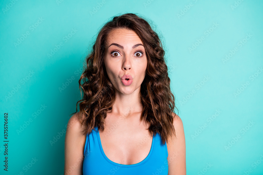 Portrait of astonished girl impressed unbelievable resort sales discount stare unexpected stupor wear blue swim suit isolated over teal turquoise color background Portrait of astonished girl impressed unbelievable resort sales discount stare unexpected stupor wear blue swim suit isolated over teal turquoise color background
