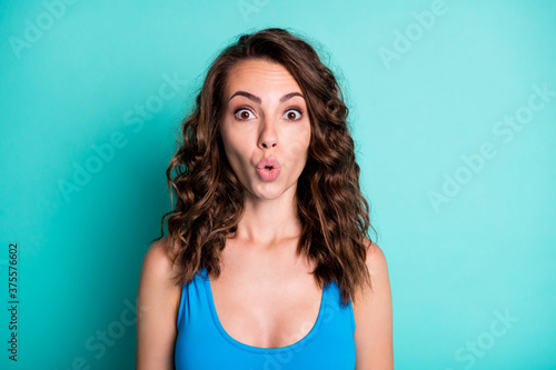 Portrait of astonished girl impressed unbelievable resort sales discount stare unexpected stupor wear blue swim suit isolated over teal turquoise color background