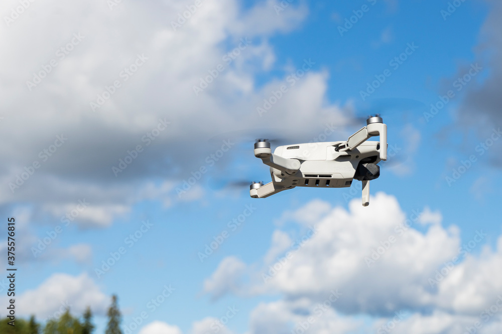selective focus, flying drone, quadrocopter, against the background of summer nature and greenery selective focus, flying drone, quadrocopter, against the background of summer nature and greenery