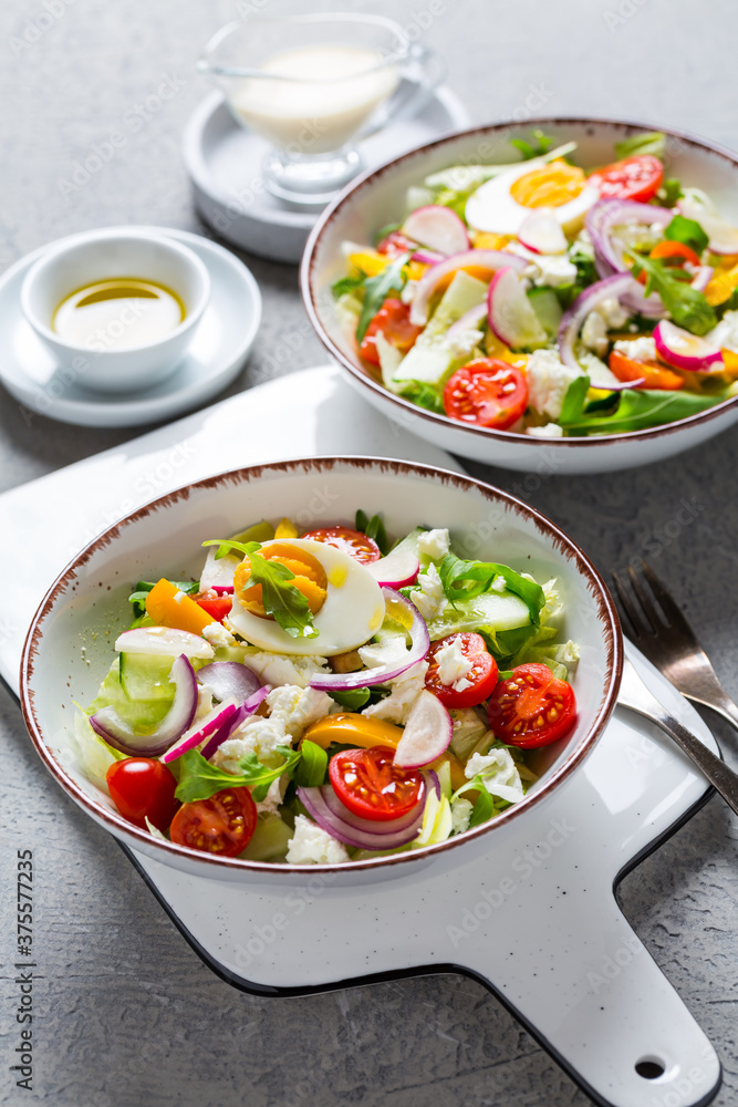 Healthy mixed salad with arugula, egg, onion, feta cheese and radish Healthy mixed salad with arugula, egg, onion, feta cheese and radish