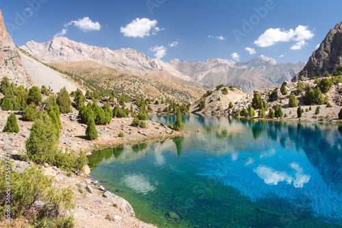 Tajikistan. Mountain landscape. Rocky path. Sunny day in Alaudin lake.