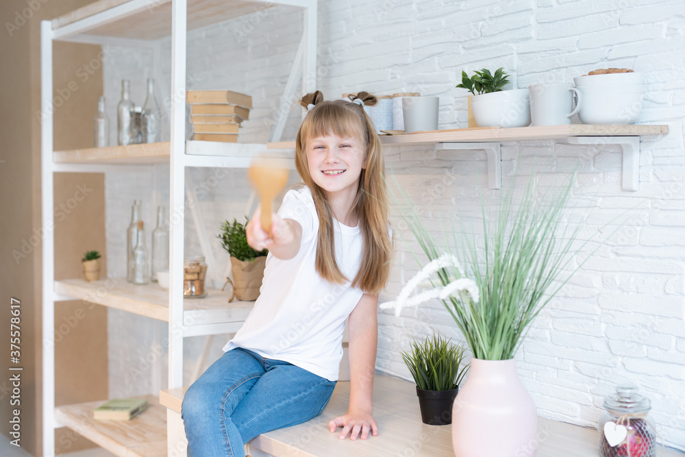 Portrait of happy smiling child girl at home. home comfort concept. Kitchen Portrait of happy smiling child girl at home. home comfort concept. Kitchen