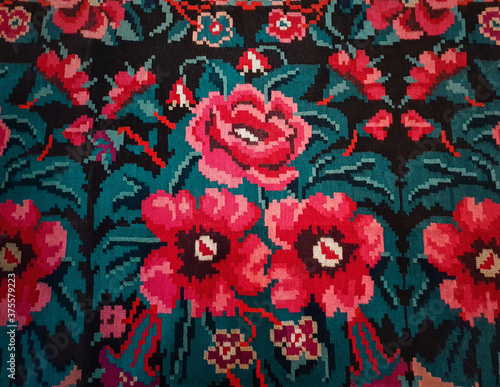 Moldovan national woven carpet, traditional floral pattern. Handcrafted vintage style rug, cultural symbol of Moldova and Romania folklore. Red flowers ornament, retro stitch. Ethnic textile motif