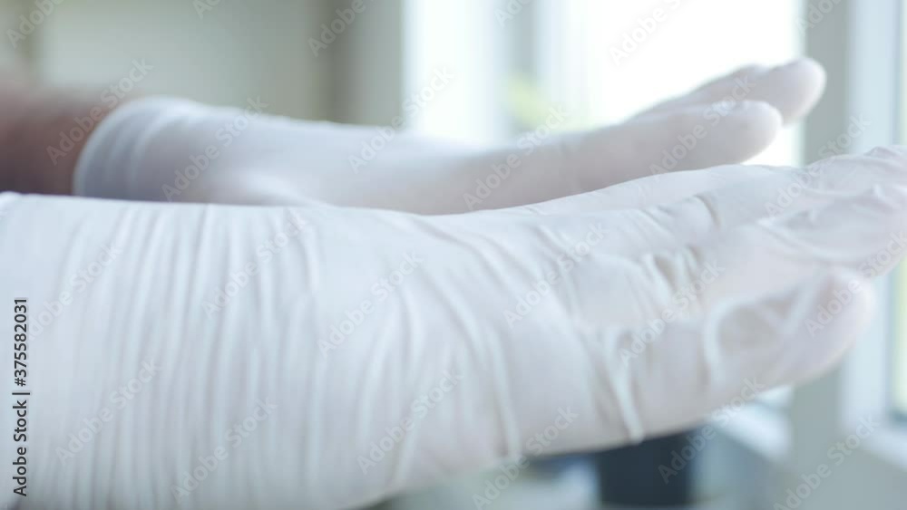 Man Fixing on His Hand's Protection Gloves Against Contamination with Covid-19, Social Distancing Lifestyle Man Fixing on His Hand's Protection Gloves Against Contamination with Covid-19, Social Distancing Lifestyle