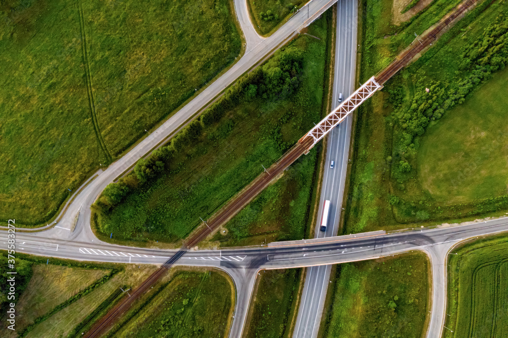 aerial top view of a multi-level highway and railroad crossing, Skulte, Latvia