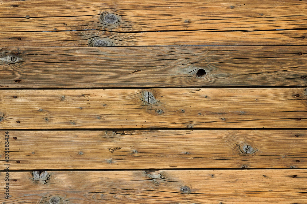 Naklejka premium Wooden floor made of old boards with knots and cracks with rusty nails