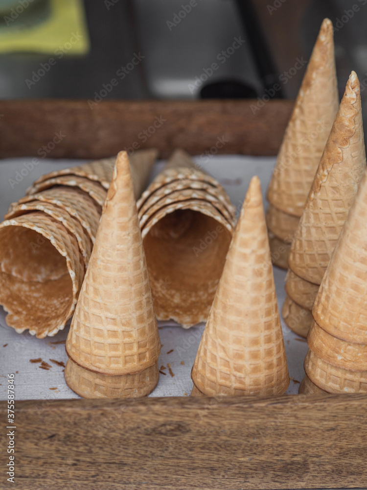 Waffle cones for ice cream on a wooden tray on sale