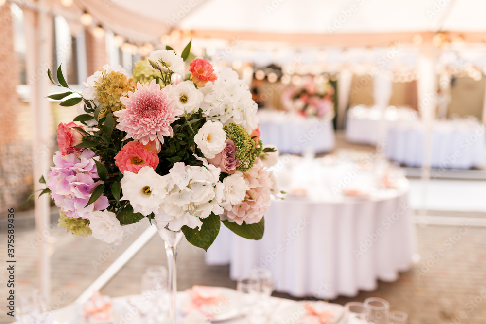 Tables for guests decorated at the banquet