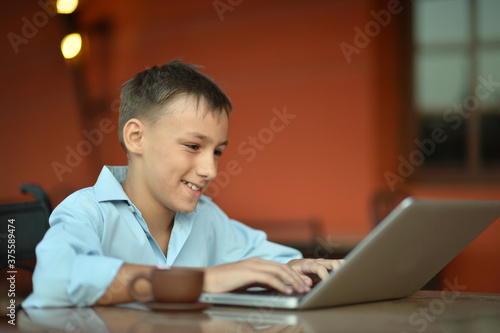 Portrait of cute boy using laptop computer
