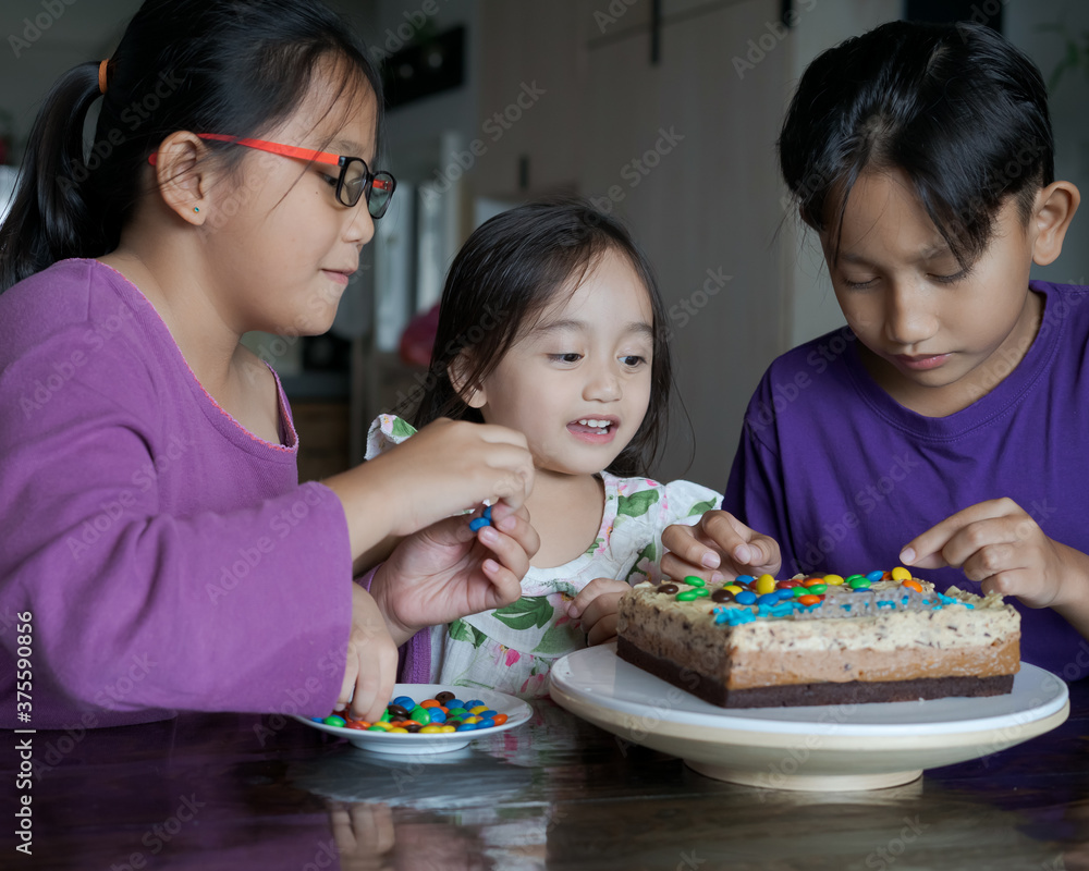 Happy family with three sibling celebrating birthday in quarantine time, self-isolation and family values, stay home, restriction movement order birthday party Happy family with three sibling celebrating birthday in quarantine time, self-isolation and family values, stay home, restriction movement order birthday party