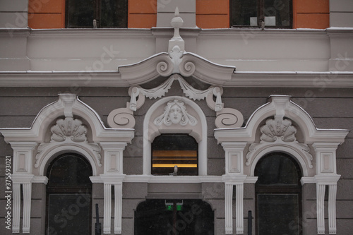 Detail of house on Baznicas street, 4a, Riga, city, Latvia, Europe. Ancient architecture with stucco molding, mascarons on old building facade. Art nouveau style. Riga landmark, monument photo