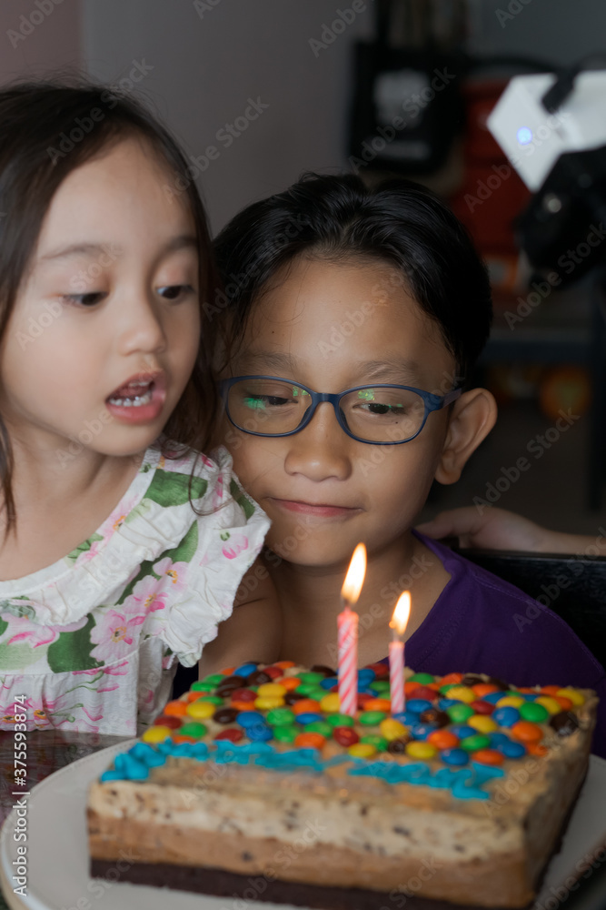 Happy family with three sibling celebrating birthday in quarantine time, self-isolation and family values, stay home, restriction movement order birthday party Happy family with three sibling celebrating birthday in quarantine time, self-isolation and family values, stay home, restriction movement order birthday party