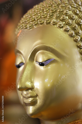 Closer look on peaceful face of Lord Buddha. © Padungsak